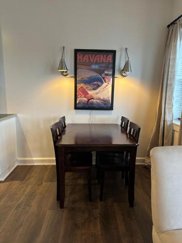 a wooden table in a living room with two chairs at Downtown Studio with Full Kitchen and Bath in Indianapolis