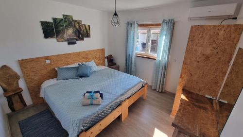 a bedroom with a bed with two bags on it at Casa Na Serra - Alagoa Blue in Oliveira de Frades