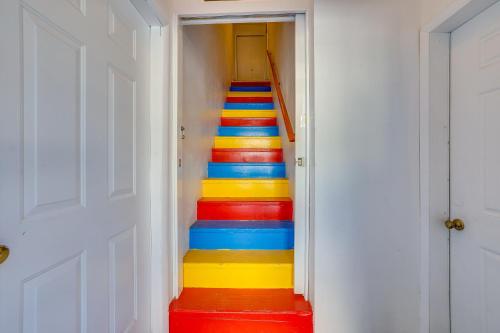 a stairway with colorful stairs in a hallway at Private Hot Tub and Mtn Views Garden Valley Apt! in Crouch
