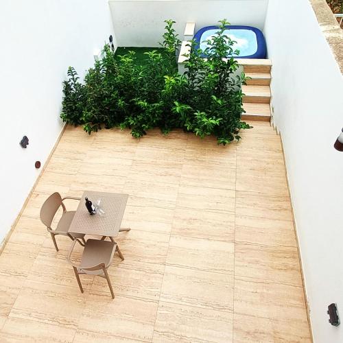 a room with a table and chairs and plants at Sea Esta Guest House in Mellieħa