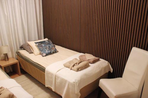 a small bedroom with a bed and a chair at Two-room apartment in the center of Helsinki with a sauna! Free parking! in Helsinki