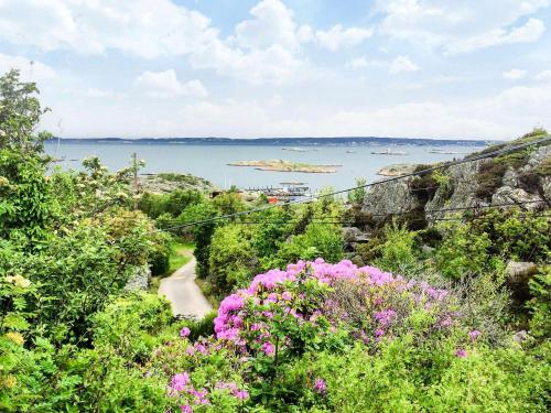 a view of the ocean from a hill with flowers at 4 star holiday home in BRäNNö in Brännö
