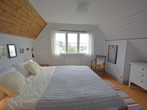 a bedroom with a large bed and a window at 10 person holiday home in Skummeslövsstrand in Skummeslövsstrand