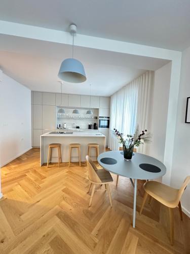a kitchen and dining room with a table and chairs at Bratislava OLDTOWN Apartment 130m2 ,60m2 terrace and 2 bathrooms in Bratislava
