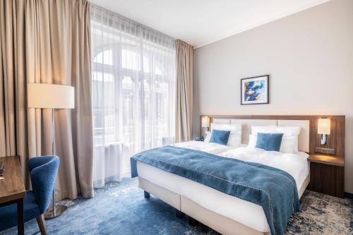 Ένα ή περισσότερα κρεβάτια σε δωμάτιο στο Garner Hotel Klagenfurt - Moser Verdino by IHG