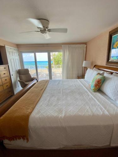 a bedroom with a bed with a view of the ocean at Oceanfront 3-BR Condo with Large Beachfront Terrace in Dog City