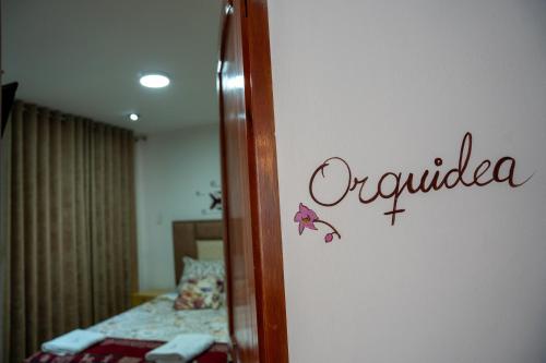 a room with a bed and a sign on a wall at Casa Antade Cusco in Cusco