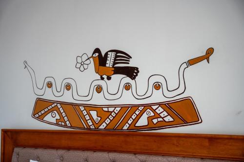 a sign on a wall with a bird on a boat at Casa Antade Cusco in Cusco