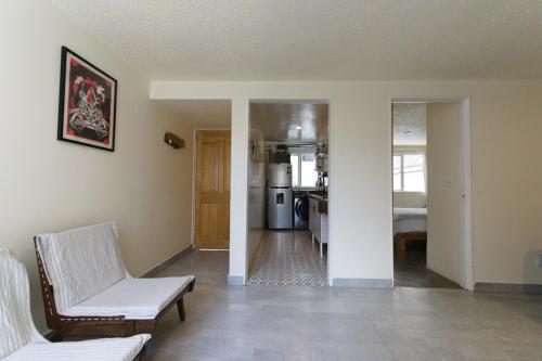 a living room with a couch and a kitchen at Alojamiento Ideal Junto al Aeropuerto CDMX in Mexico City