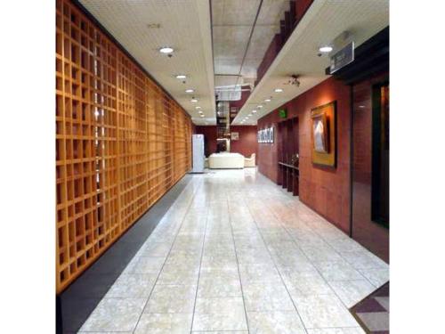 an empty hallway in a building with a wall of bricks at Central Hotel - Vacation STAY 99771v in Kusugaurachō