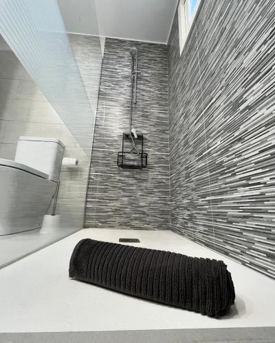 a bathroom with a large shower with a black rug at Casa Minerva in Costa Teguise