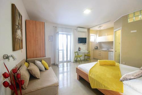 a bedroom with a bed and a couch in it at House Skrabic in Makarska