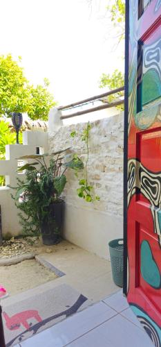 a colorful bus is parked next to a stone wall at Chambao Maldives in Guraidhoo