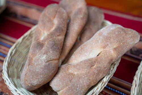 a bunch of bread in a basket on a table at Casa Antade Cusco in Cusco