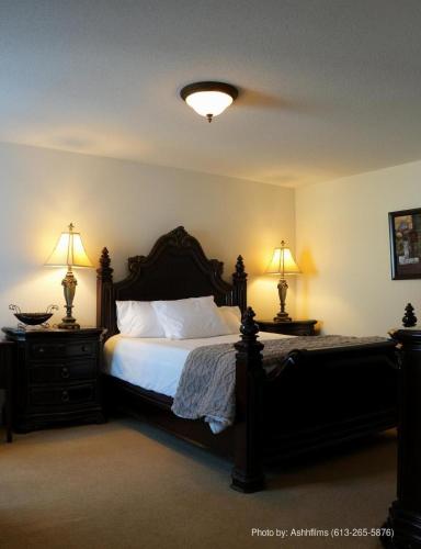 a bedroom with a large bed with two night stands at Fosterbrook Parkside Retreat in Ottawa