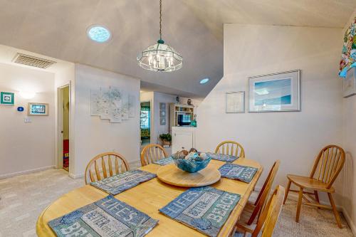 a dining room with a wooden table and chairs at Savannahs Landing --- 10 Mary Elizabeth Dr in Ocean View