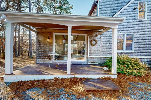 a front porch of a house with awning at National Seashore Retreat in Eastham