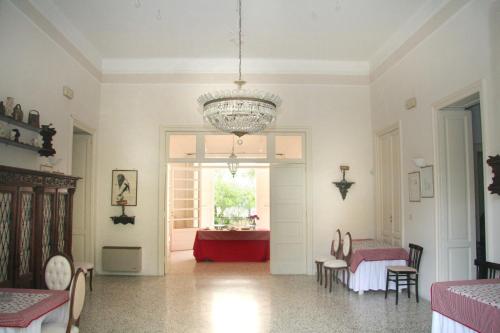 a living room with a chandelier and a red couch at B&B Villa Pallante in Bari