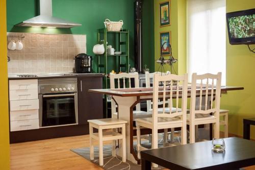 a kitchen with a table and chairs and a stove at La Casa De Luarca in Luarca