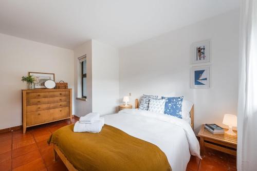 a bedroom with a bed and a dresser in it at GuestReady - Countryside dream in Caminha in Caminha