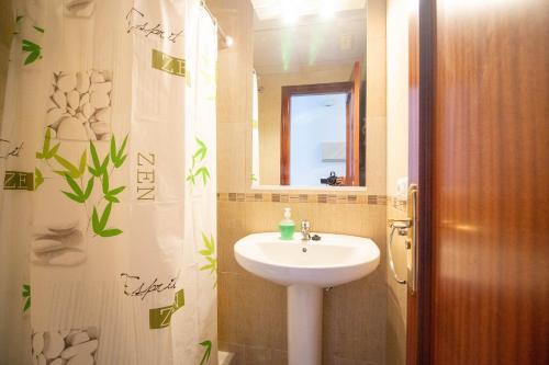 a bathroom with a sink and a mirror at SpainKarmaSun in Torrox Costa
