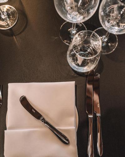 a table with a knife and fork and wine glasses at Mövenpick Resort & Spa Karpacz in Karpacz