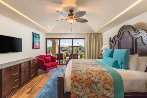 a bedroom with a large bed and a flat screen tv at Vista Encantada Resort & Spa Residences, A La Carte All Inclusive Optional in Cabo San Lucas