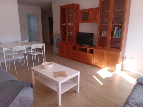 a living room with a couch and a table at Paseo de noia in Noya