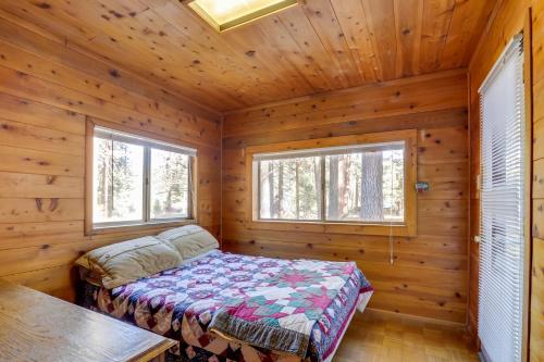 a bedroom with a bed in a log cabin at Quaint and Rustic A-Frame Less Than 5 Mi to Plumas-Eureka! in Plumas Eureka