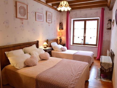 a bedroom with two beds and a window at Longère XIXe rénovée avec spa, trampoline, vélos, jeux et grand jardin au calme - FR-1-410-135 in Saint-Calez-en-Saosnois