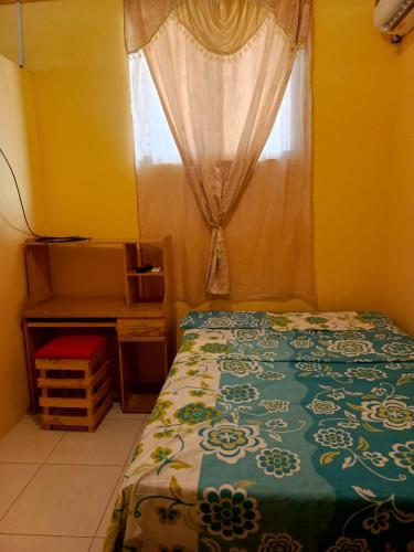 a bedroom with a bed in front of a window at Casa de Tania in Puerto Baquerizo Moreno