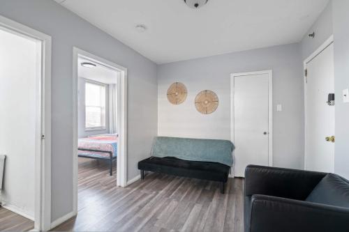 a living room with a couch and a mirror at The Oakden Suites in Orange Loop A5 in Atlantic City
