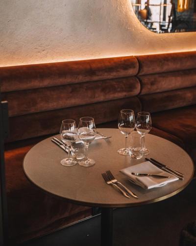 a table with wine glasses and silverware on it at Mövenpick Resort & Spa Karpacz in Karpacz