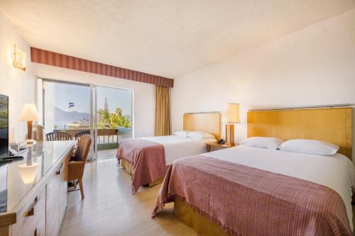 Ένα ή περισσότερα κρεβάτια σε δωμάτιο στο Porta Hotel del Lago