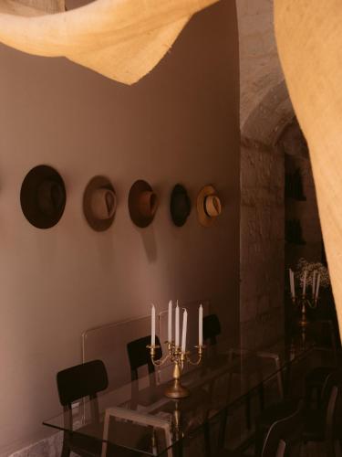 a dining room with a glass table with candles at CIRQA - Relais & Châteaux in Arequipa