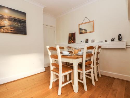 a dining room with a table and chairs at Pound Rocks in Tintagel
