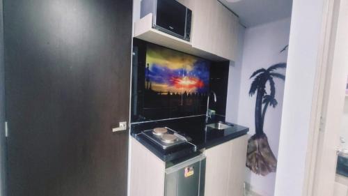 a bathroom with a sink and a painting on the wall at Las Aguas Inner Experience in Bogotá