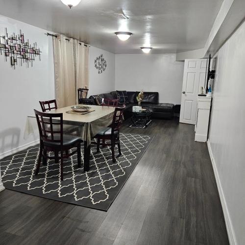 a living room with a table and chairs and a couch at Queen bedroom in Toronto