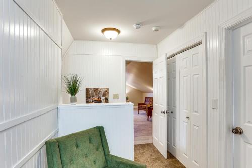 a hallway with a green chair in a room at Hersheypark 6 Mi Away Family Getaway with Fire Pit in Palmyra
