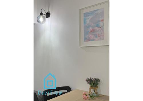 a dining room with a table and a picture on the wall at Ocean Room - 1 km to Baltic Sea & 15 Minutes to Gdańsk Old Town in Gdańsk
