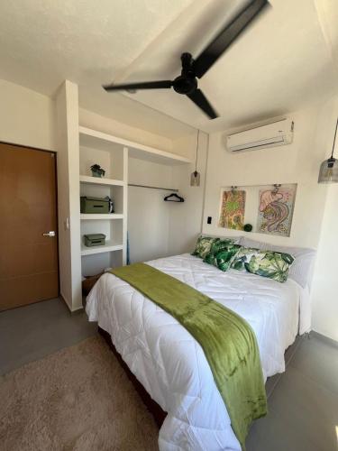 a bedroom with a bed with a ceiling fan at Casa Monstera te espera in Naranjo