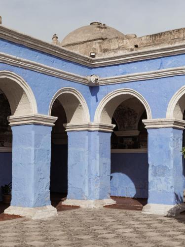 a blue building with arches and a dome at CIRQA - Relais & Châteaux in Arequipa