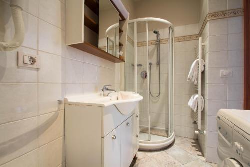 a bathroom with a sink and a shower at Hotel Corso Alaxi Hotels in Alassio