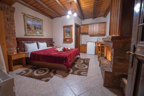 a bedroom with a large bed and a kitchen at Το Πατρικό in Kato Loutraki