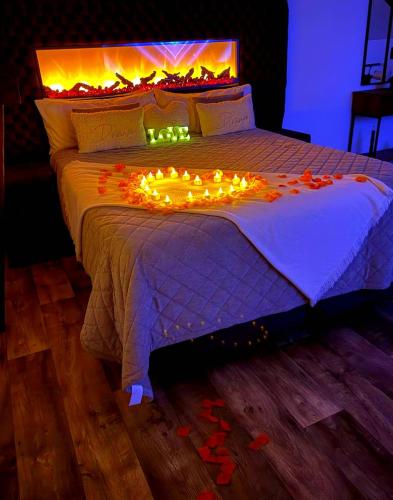 a bed with a bunch of lights on it at Love Room Spa - Sauna - Hammam in Domérat