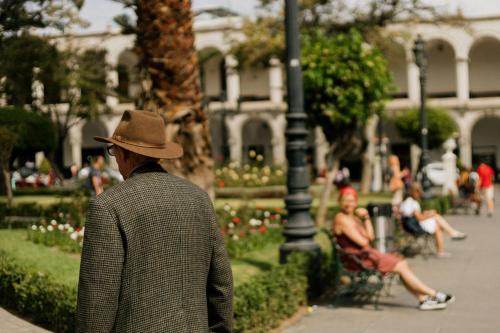 a man in a hat walking in a park at CIRQA - Relais & Châteaux in Arequipa