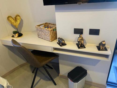 a desk with a chair and some figurines on it at Hotel Living 35 Suites Piso 8 Vip in Medellín