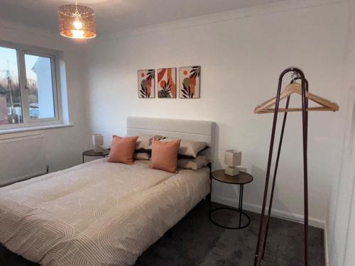 a bedroom with a bed with two tables and a window at Modern 3 bedroom detached house in Sutton Bridge