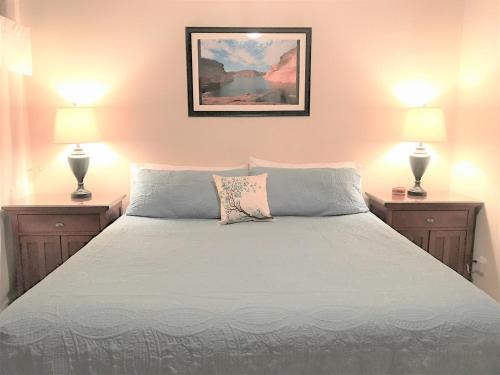 a bedroom with a white bed with two lamps at Local VIEW Pet Friendly BOAT Parking Close to Antelope Canyon HorseshoeBend in Page