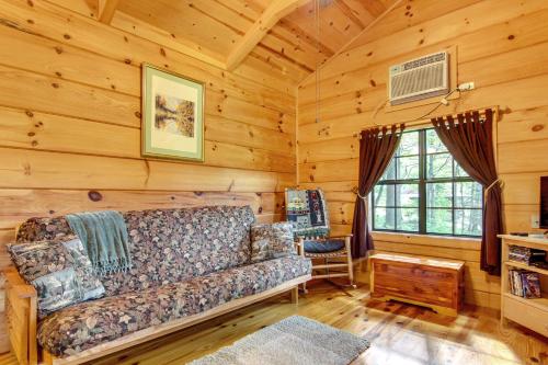 a living room with a couch in a log cabin at Hendersonville Cabin Near Hiking and Waterfalls! in Hendersonville